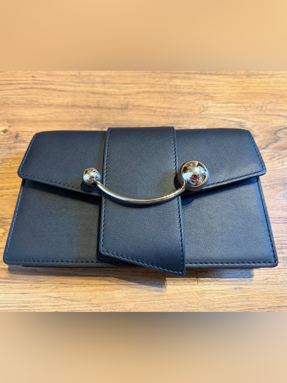 Strathberry Black Leather Crescent on a Chain Handbag with Gold-Tone Bar
